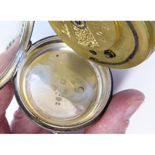 205 - A silver cased pocket watch, faced by a floral engraved and gilded Roman dial, on a silver curb link... 