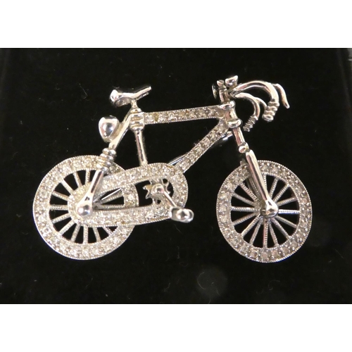 21 - An 18ct white gold and diamond set brooch, fashioned as a bicycle