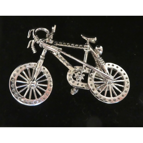 21 - An 18ct white gold and diamond set brooch, fashioned as a bicycle