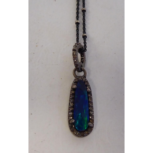 225 - A black opal set pendant, on a fine neckchain