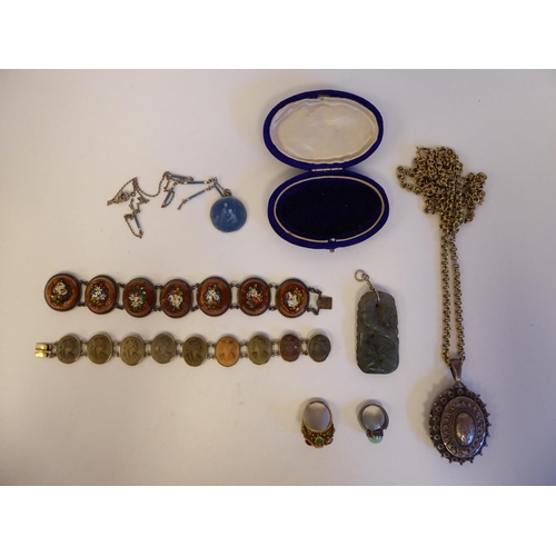 228 - Items of personal ornament: to include an oval silver pendant, decorated in ethnic taste, on a white... 