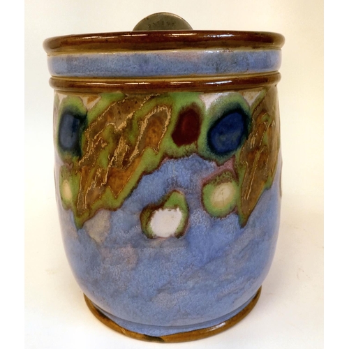 23 - A Royal Doulton stoneware tobacco jar with a rotating catch on the lid, decorated in random colours ... 