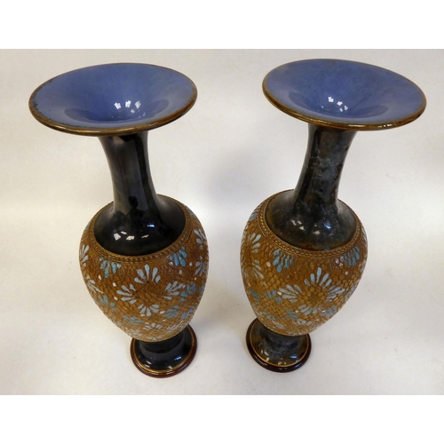 239 - A pair of early 20thC Royal Doulton stoneware, ovoid shape vases with narrow necks and flared rims, ... 