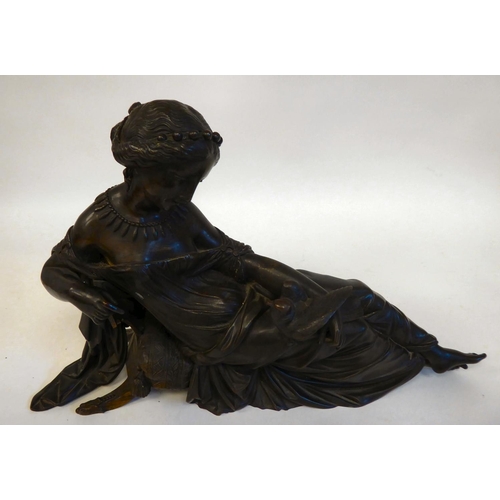 240 - A late 19thC cast and patinated bronze figure, a young woman reclining on a cushioned stool, looking... 