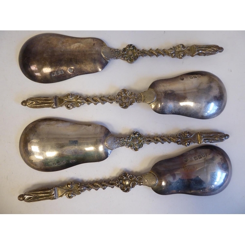 255 - A set of four silver and parcel gilt apostle spoons, the pear shaped bowls on entwined, twist handle... 