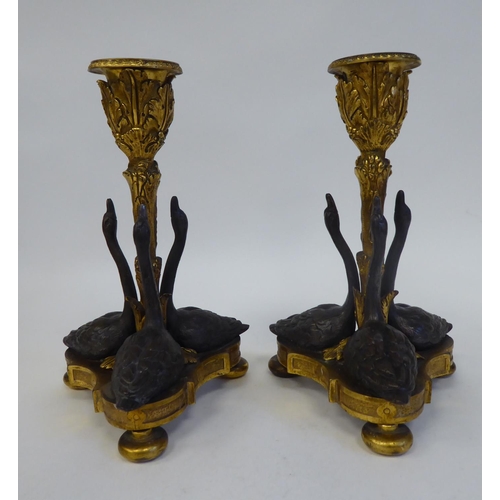 256 - A pair of gilt and patinated bronze candlesticks, designed by William Bateman II for Rundall, Bridge... 