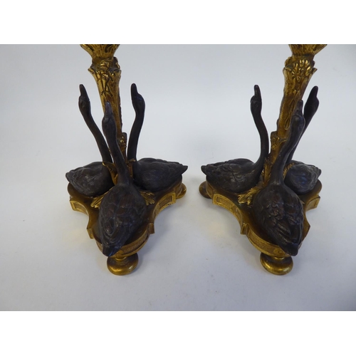 256 - A pair of gilt and patinated bronze candlesticks, designed by William Bateman II for Rundall, Bridge... 