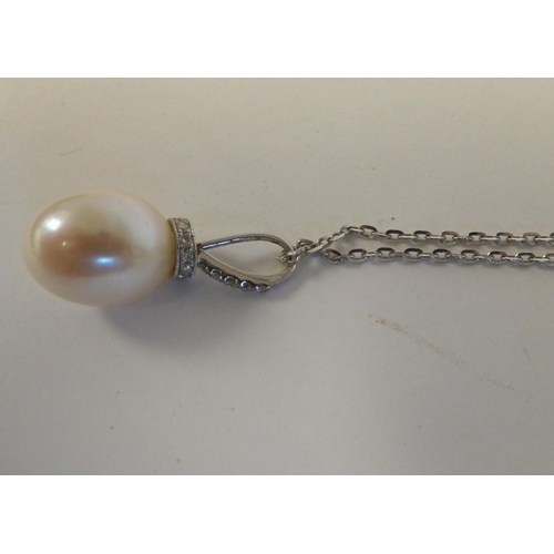 26 - An 18ct white gold and diamond set, single pearl pendant, on a fine neckchain and ring bolt clasp