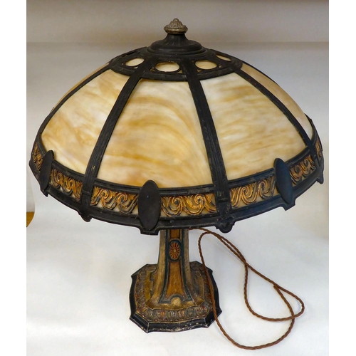 269 - An Arts & Crafts painted metal table lamp with a tapered column, on a decoratively formed base, ... 