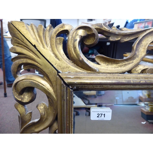 271 - A 19thC mirror with a later bevelled plate, set in a carved giltwood scrolled frame  26