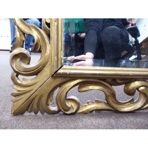 271 - A 19thC mirror with a later bevelled plate, set in a carved giltwood scrolled frame  26