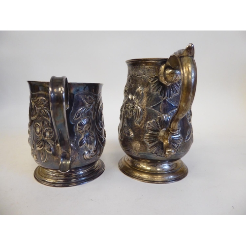 274 - A George II silver mug with an S-shape handle, embossed and scrolled ornament  Elizabeth Goodwi... 