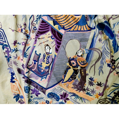 276 - An early 20thC Japanese silk piano shawl, decorated in colours with figures and blossom within a wid... 