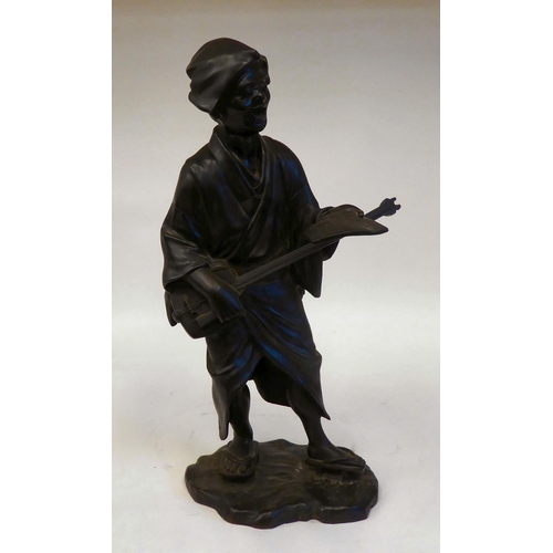 286 - A 19thC Japanese figure, an itinerant man playing a stringed instrument, whilst holding sheet music&... 