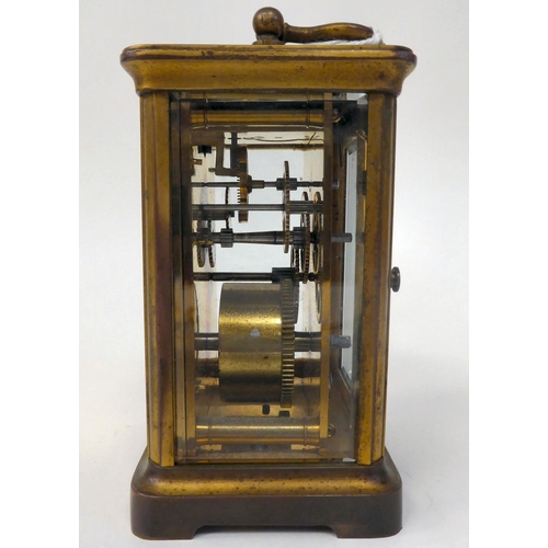 287 - A mid 20thC brass cased carriage timepiece with bevelled glass panels and a folding top handle; the ... 