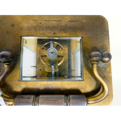 287 - A mid 20thC brass cased carriage timepiece with bevelled glass panels and a folding top handle; the ... 