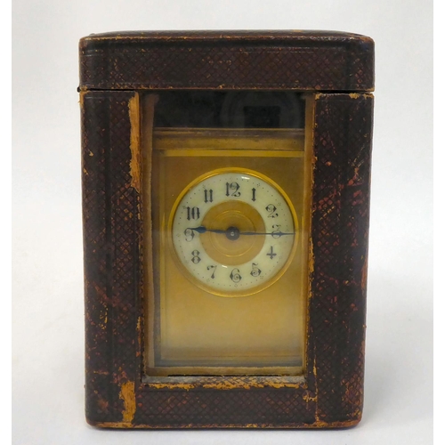 287 - A mid 20thC brass cased carriage timepiece with bevelled glass panels and a folding top handle; the ... 