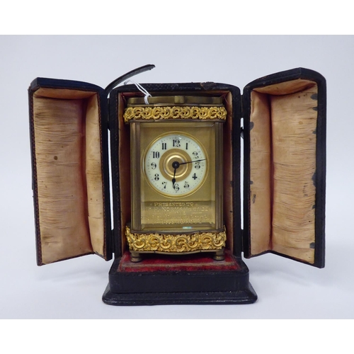 288 - A mid 20thC gilt metal cased carriage timepiece with decoratively cast frieze ornament, beaded glass... 