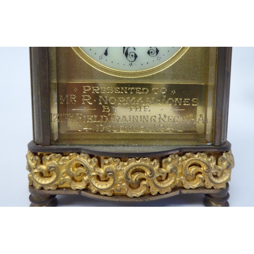 288 - A mid 20thC gilt metal cased carriage timepiece with decoratively cast frieze ornament, beaded glass... 