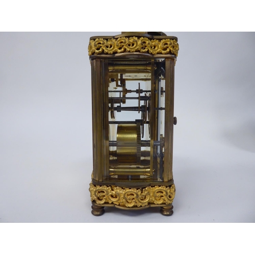 288 - A mid 20thC gilt metal cased carriage timepiece with decoratively cast frieze ornament, beaded glass... 