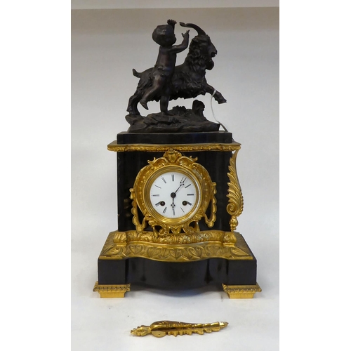 289 - A late 19thC black slate cased and gilt metal mounted mantel clock, surmounted by a classical 'goat ... 