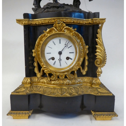 289 - A late 19thC black slate cased and gilt metal mounted mantel clock, surmounted by a classical 'goat ... 