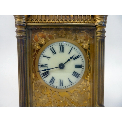 295 - A mid 20thC gilt metal cased carriage timepiece with outset pillow fretworked decoration, bevelled g... 