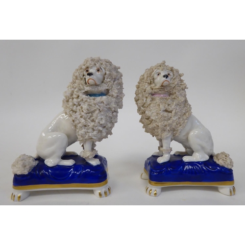 297 - A pair of mid 19thC Chelsea porcelain model lions, each seated on a pillow  3.5