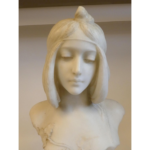 3 - An Art Nouveau carved white marble bust, a maiden with her hair tied back and ornamented with traili... 