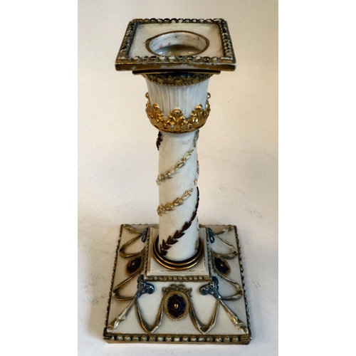 33 - A Royal Worcester biscuit glazed china candlestick, decorated in neo-classical taste with silvered r... 