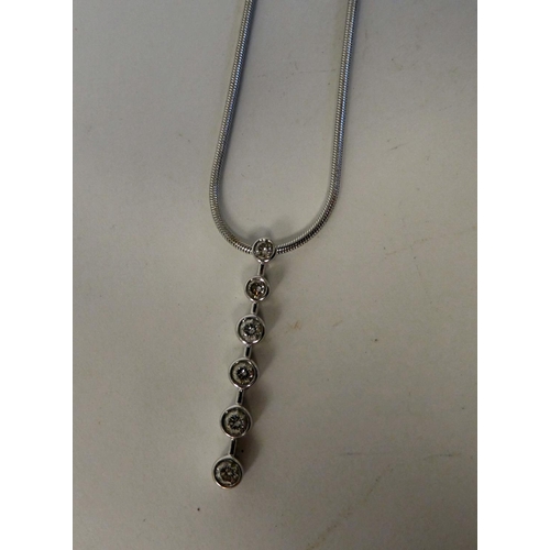 35 - An 18ct white gold necklet, set with a six stone diamond pendant, on a fine snake link chain and dog... 