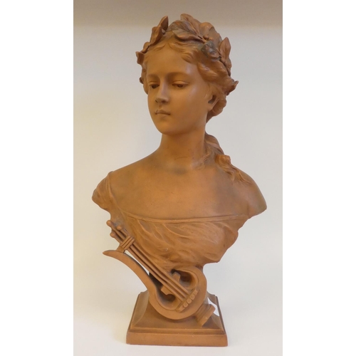 42 - An Art Nouveau terracotta bust, a young girl with fruiting vine in her hair, on a socle, incorporati... 