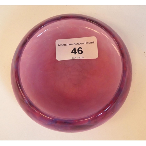 46 - A Moncrieff Monart glass pin dish, decorated in tones of purple/pink  bears an applied label  4