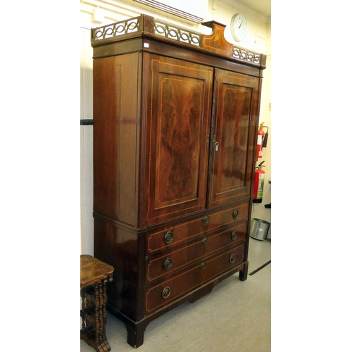 53 - An early 19thC satinwood inlaid, mahogany linen press with a pierced, fretworked cornice, over two p... 