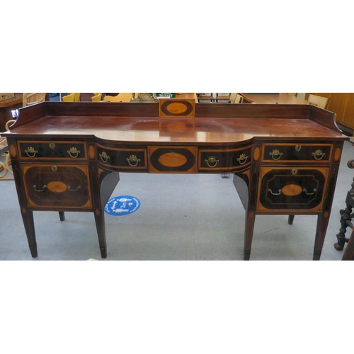 54 - A Regency Irish satinwood inlaid, mahogany breakfront sideboard with three inline drawers, above a c... 