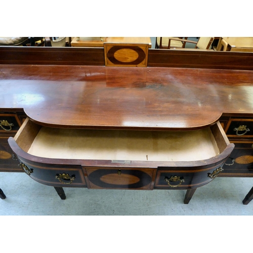 54 - A Regency Irish satinwood inlaid, mahogany breakfront sideboard with three inline drawers, above a c... 