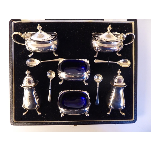 56 - A silver six piece condiments set, comprising a pair of salt cellars, lidded mustards, pepper pots a... 