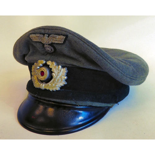 58 - A World War II German Luftwaffe peaked cap with emblems(Please Note: this lot is subject to the stat... 