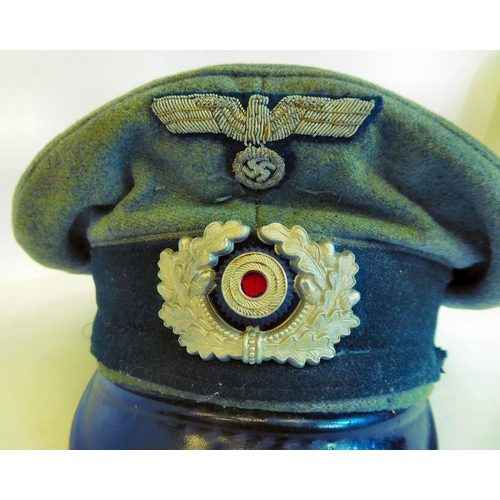 58 - A World War II German Luftwaffe peaked cap with emblems(Please Note: this lot is subject to the stat... 