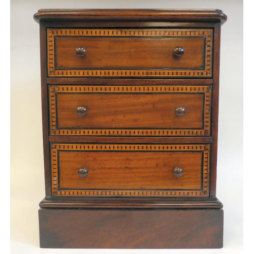 7 - A late 19thC mahogany table top collector's chest with three graduated long drawers and inlaid borde... 