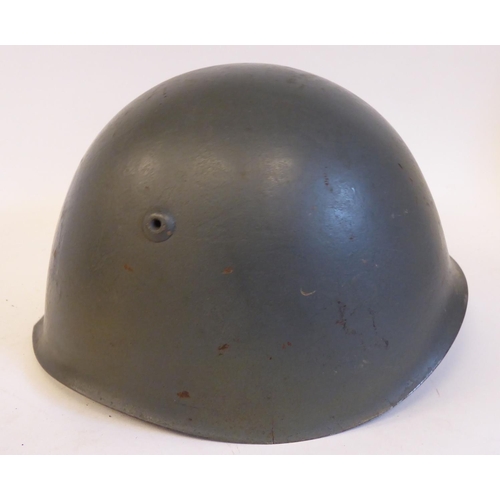 72 - An Italian grey painted steel Civil War Volunteers helmet with a hide liner and buckled chinstrap, b... 