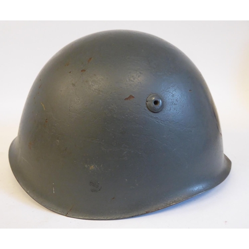 72 - An Italian grey painted steel Civil War Volunteers helmet with a hide liner and buckled chinstrap, b... 