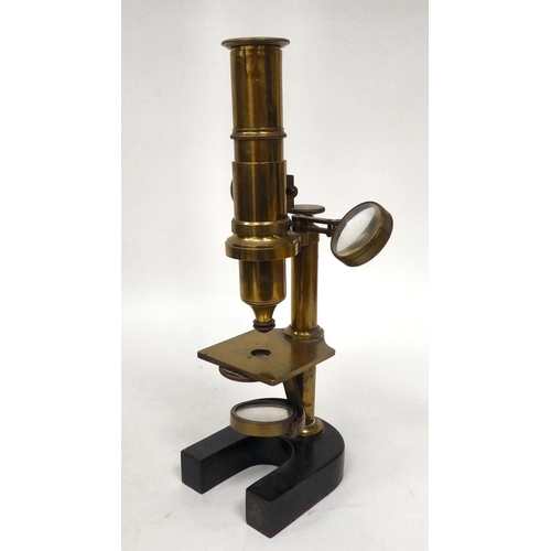 76 - A late 19thC cast iron and lacquered brass microscope with an adjustable mirror, single barrel, lens... 