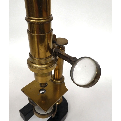 76 - A late 19thC cast iron and lacquered brass microscope with an adjustable mirror, single barrel, lens... 