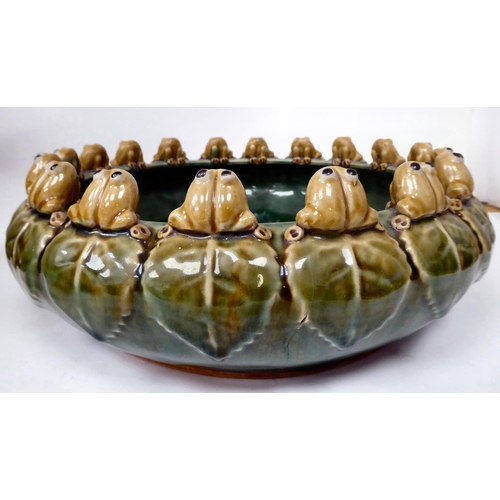 81 - A 20thC green and brown glazed earthenware bowl of shallow form, the incurved rim set with eighteen ... 