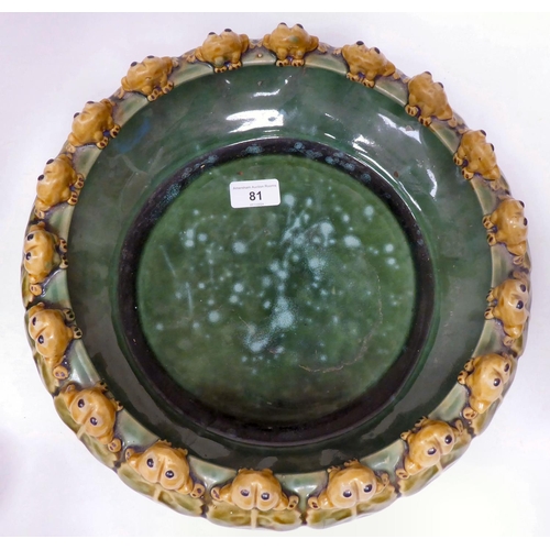 81 - A 20thC green and brown glazed earthenware bowl of shallow form, the incurved rim set with eighteen ... 