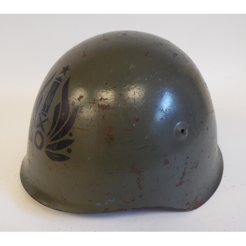 86 - An Italian grey painted steel Civil War Volunteers helmet with a hide liner and buckled chinstrap, b... 