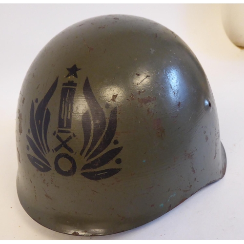 86 - An Italian grey painted steel Civil War Volunteers helmet with a hide liner and buckled chinstrap, b... 