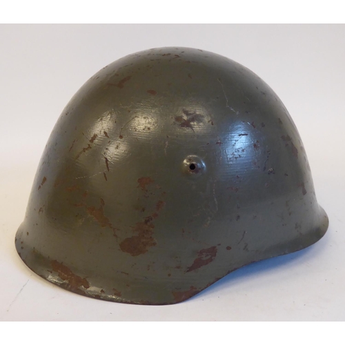 86 - An Italian grey painted steel Civil War Volunteers helmet with a hide liner and buckled chinstrap, b... 