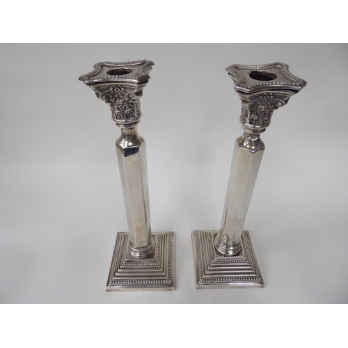 88 - A pair of Victorian silver candlesticks with bead bordered Corinthian capitals and straight, hexagon... 